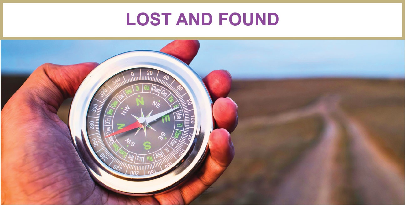 Hand holding a compass beside an open road, symbolizing rediscovering purpose and direction through leadership coaching